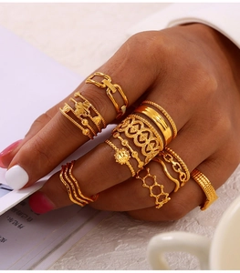 Close-up of a 10-piece gold-plated bohemian ring set with intricate vintage carvings