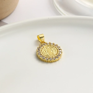 Close-up of gold Saint Benedict pendant featuring a sparkling cubic zirconia halo inlay