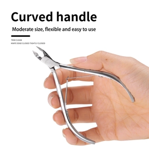 Close-up of ergonomic curved handle stainless steel cuticle nipper held by hand