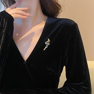 Exquisite gold-plated dragon brooch with sparkling zircons on elegant black velvet dress