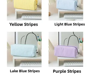 Detailed grid view of seersucker pencil cases in yellow, blue, and purple stripes