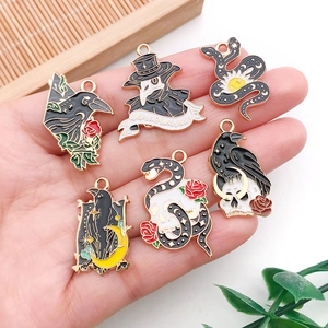 Set of 6 Gothic black metal charms featuring crow, snake, rose, moon and skull motifs