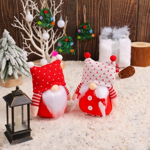Pair of Christmas faceless gnomes with red and white knit hats in a festive snowy scene