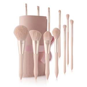 Pink makeup brush set of 10 with gold tubes and beige bristles in a matching PU leather bucket