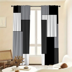 Detail of modern black and grey geometric pattern curtains in a bright living room