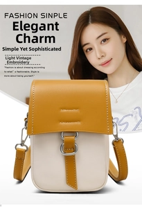 Detailed close-up of yellow and beige vertical crossbody phone bag with metal clasp