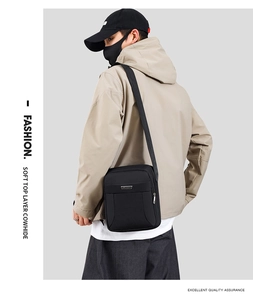 Detail view of black leather shoulder bag showing texture and high-quality metal logo