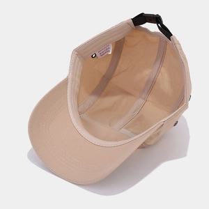 Internal view of beige quick-dry five-panel baseball cap with polyester fabric texture