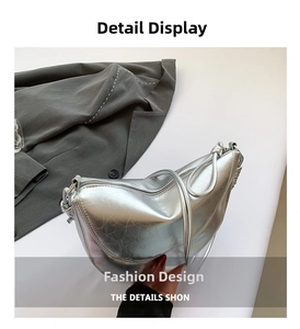 Close-up of silver metallic leather crossbody bag featuring smooth texture and thin strap