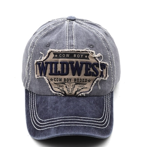 Detailed close-up of Wild West embroidery and vintage stitching on a washed denim cap