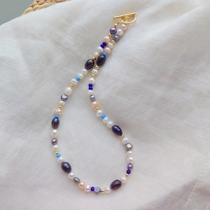 Vintage necklace with white pearls, purple and blue beads featuring a gold T-bar clasp