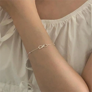 Minimalist S925 sterling silver infinity bracelet featuring a delicate cable chain on wrist