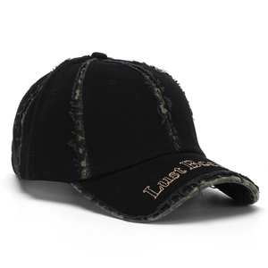 Detailed side view of street style baseball cap with distressed brim and gold embroidery
