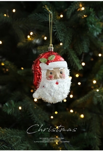 Detailed Santa Claus ornament with glitter beard hanging on a festive Christmas tree