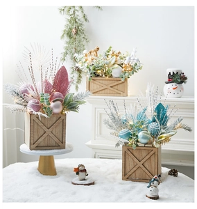 Mini lighted Christmas tree centerpieces in wooden pots with colorful ornaments set