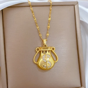 Macro shot of gold money bag pendant necklace featuring a sparkling dollar sign crystal detail