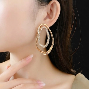 Elegant gold plated double hoop oval earrings with micro-pave crystals on female model