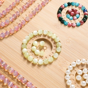 Macro detail of natural wooden jewelry design tray with color-gradient gemstone beads