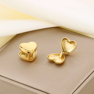Minimalist gold titanium steel heart earrings in open and closed views on jewelry box