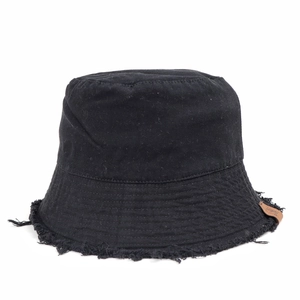 Close-up of black canvas bucket hat showing raw fringe edges and brown leather patch