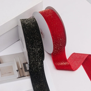 Detail of red and black velvet ribbons with gold glitter for gift wrapping decoration