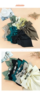 Detail view of large satin bow hair clip with strong metal spring clip and layered fabric