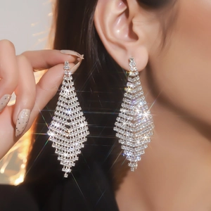 Detailed close-up of luxurious long silver tassel earrings with sparkling rhinestones