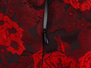 Macro shot of red floral jacquard fabric with a hidden zipper on a vintage dress