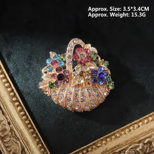 Close-up of vintage baroque flower basket brooch with colorful rhinestones on black velvet