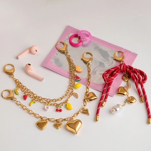 Chic 18K gold plated heart and fruit bag charms with pearls on white background