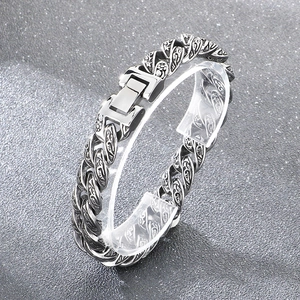 Detailed view of punk style silver steel Cuban bracelet with vintage floral carvings