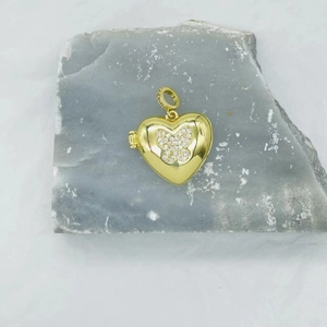 Golden heart locket necklace with butterfly zircon inlay on natural grey stone