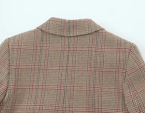 Detail of houndstooth plaid blazer showing the collar construction and fine fabric texture