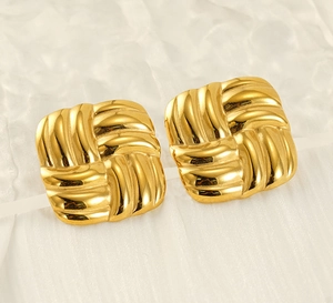 Macro detail of 18k gold plated stainless steel square earrings with woven texture