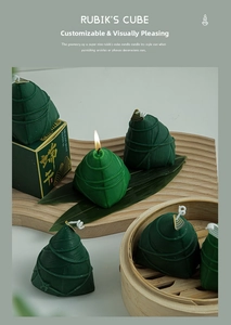 Detail of zongzi-shaped scented candle in dark green with realistic texture and gift box