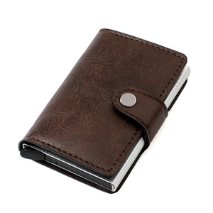 Close-up of slim brown leather RFID wallet with pop-up aluminum card holder mechanism