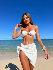 Detailed texture of white ribbed bandeau bikini top with ring and matching beach sarong