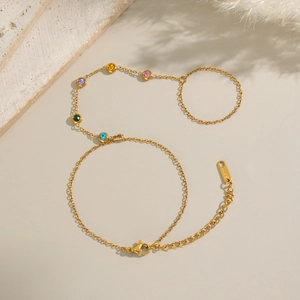 Detailed view of gold stainless steel bracelet with five colorful round cut gemstones