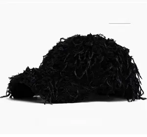 Detail shot of black fuzzy baseball cap showing plush faux fur texture and brim fibers