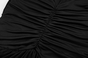 Detailed macro view of ruching technique and pleated fabric on a black V-neck dress