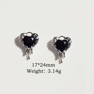 Detail of silver alloy heart pendants with black gemstones and liquid metal effect