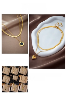 Detail showing gold titanium double layer necklaces with lucky letter and heart pendants