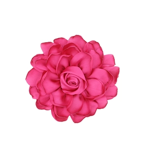 Detailed view of layered rose pink satin fabric petals for DIY floral accessories