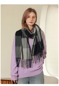 Close-up of black and grey checkered scarf with soft tassels worn by a model