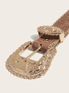 Detail of western retro belt with ornate golden buckle and embossed brown leather texture