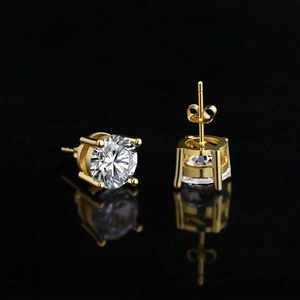 Macro shot of gold four-prong stud earrings with round brilliant cubic zirconia stones