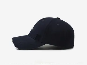 Detailed side view of distressed baseball cap showing white embroidery and frayed brim