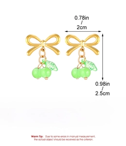 Detail view of bow earrings with green beads and stainless steel material specs