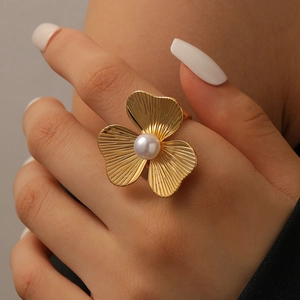 Macro view of 18K gold plated petal ring featuring fine texture and a center pearl
