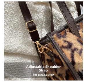 Detail of adjustable leather strap and golden hardware on leopard faux fur handbag